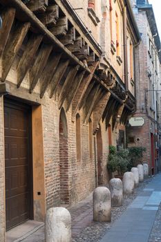 Medieval street in Ferrara with a Trattoria