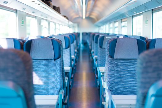 Modern european economy class fast train interior. Inside of high speed train compartment.