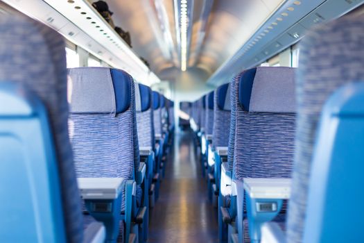 Modern european economy class fast train interior. Inside of high speed train compartment.