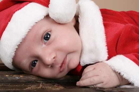 Cute baby boy wearing a christmas suit 