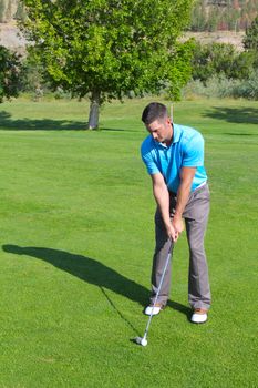 Young golfer hitting a shot with an iron 