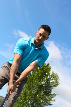 Young golfer hitting a shot with an iron 