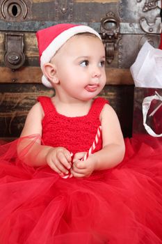 Brunette christmas baby girl wearing a long red tulle dress