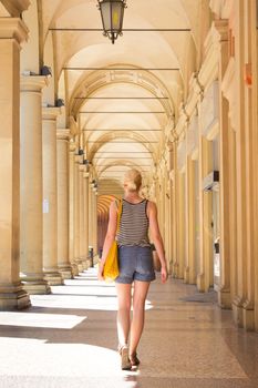 Lady walking the old traditional streets of Bologna, Italy.