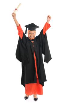 Portrait of full length smiling Asian female Muslim student in graduate gown hands raised showing graduation diploma standing isolated on white background.