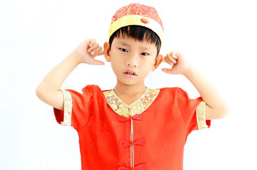 China boy in traditional Chinese red Tang suit greeting