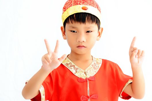 China boy in traditional Chinese red Tang suit greeting