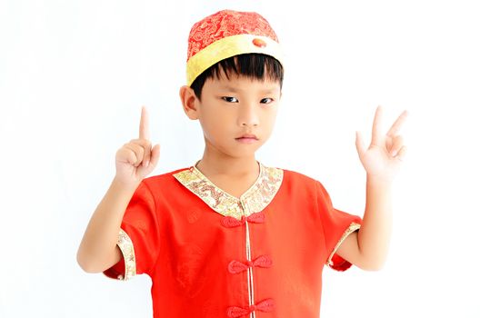 China boy in traditional Chinese red Tang suit greeting