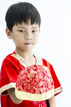 China boy in traditional Chinese red Tang suit greeting