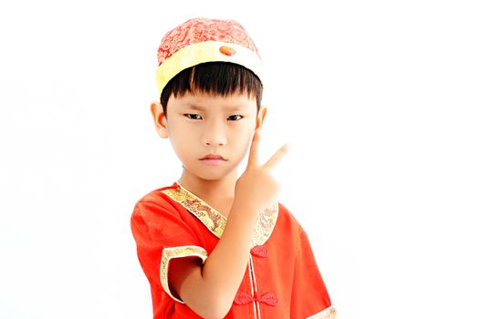 China boy in traditional Chinese red Tang suit greeting