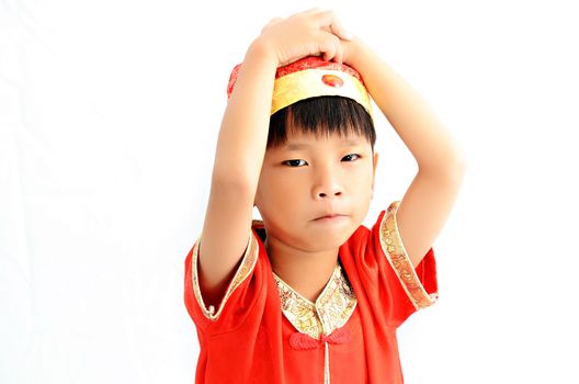 China boy in traditional Chinese red Tang suit greeting