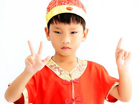 China boy in traditional Chinese red Tang suit greeting