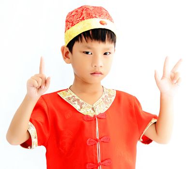 China boy in traditional Chinese red Tang suit greeting