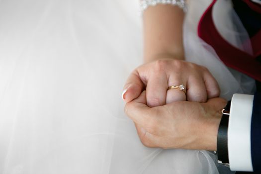 wedding theme, holding hands newlyweds. Close up