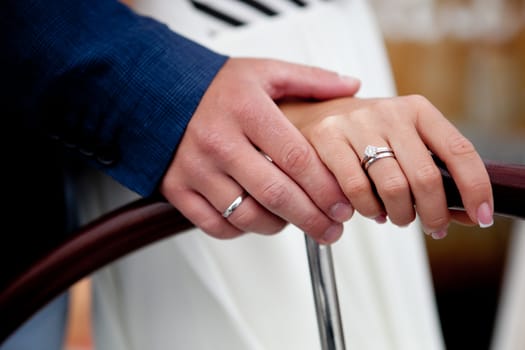 wedding theme, holding hands newlyweds. Close up