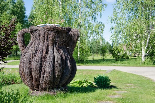 dekorative big pitcher weaved from dried birch branches in village outdoor