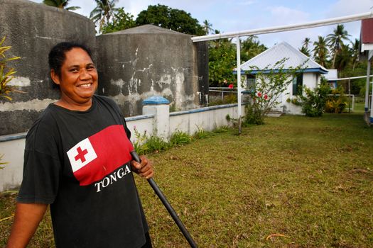 Local woman cleaning church yard, Ofu island, Vavau group, Tonga