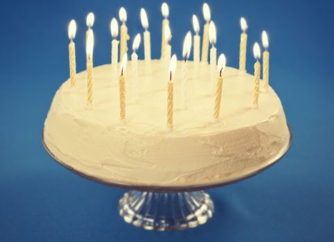 Birthday cake with candles on blue background