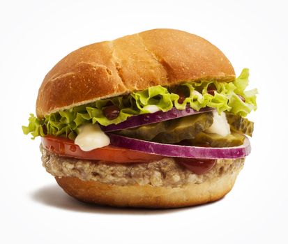 Delicious burger with tomatoes, onion, pickles and lettuce