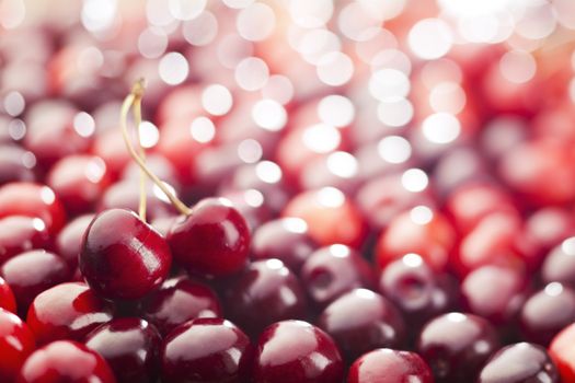Red cherries background. Shallow depth of field.