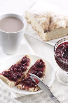 Breakfast of tasty red cherry jam on toast