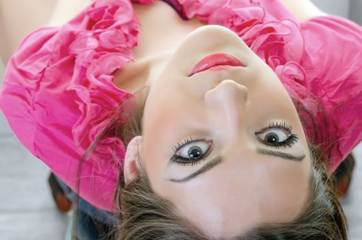 Closeup of Young brunette with green eyes looking backwards, horizontal shot from upper angle