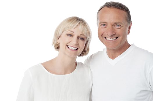 Smiling loving couple standing on white background