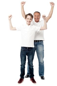 Father and son celebrating their success with raised arms.