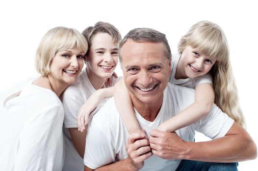 Happy family, father giving daughter a piggyback ride