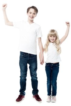 Children posing with holding and raising hands 