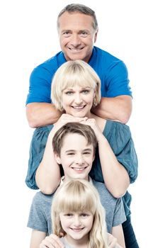 Happy family of four smiling and standing together