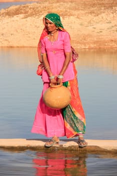Local woman getting water from reservoir, Khichan village, Rajasthan, India