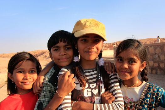 Group of local kids playing near water reservoir, Khichan village, Rajasthan, India