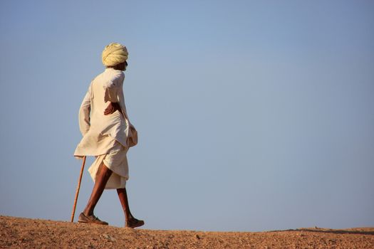 Local man walking on a hill, Khichan village, Rajasthan, India
