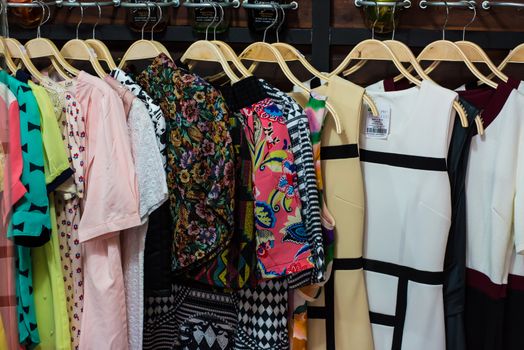 Colorful blouse hanging on clothesline in a shop.