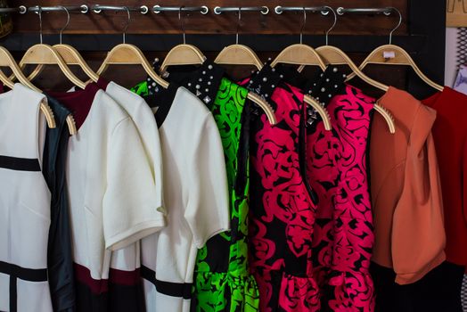 Colorful blouse hanging on clothesline in a shop.