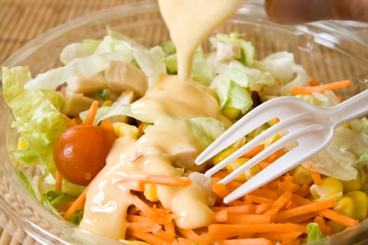 Closeup of take away bowl with fast food salad