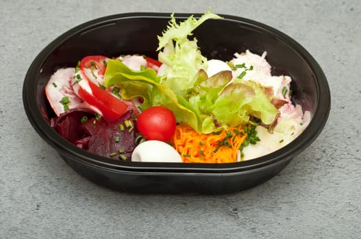 Closeup of take away bowl with fast food salad