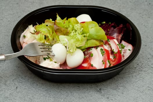 Closeup of take away bowl with fast food salad