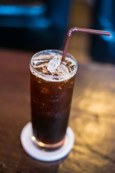 Ice black Coffee on the wooden table in the cafe.