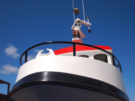 Prow of a small ferry boat with clear blue sky background  