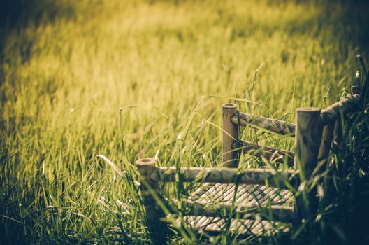 Bamboo wooden chairs on grass field in countryside Thailand vintage