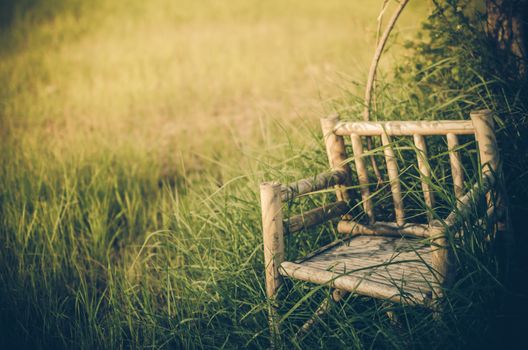 Bamboo wooden chairs on grass field in countryside Thailand vintage