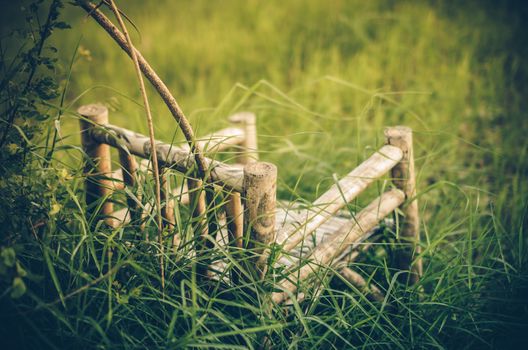 Bamboo wooden chairs on grass field in countryside Thailand vintage