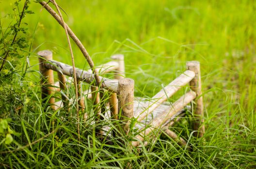 Bamboo wooden chairs on grass field in countryside Thailand