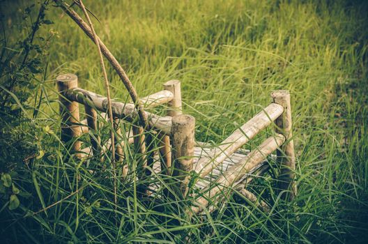 Bamboo wooden chairs on grass field in countryside Thailand vintage