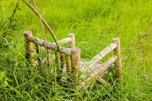 Bamboo wooden chairs on grass field in countryside Thailand