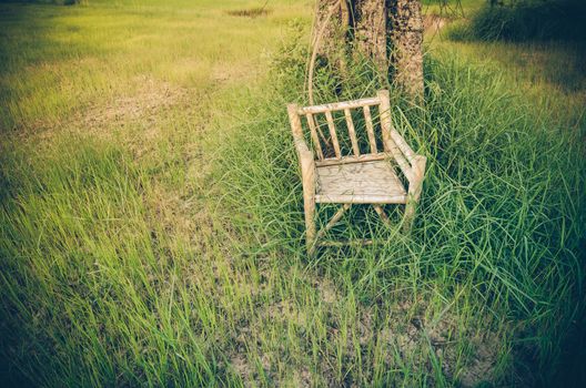 Bamboo wooden chairs on grass field in countryside Thailand vintage