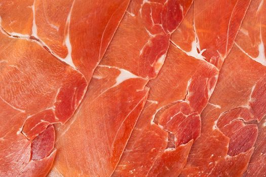 Spanish jamon iberico sliced, as a background