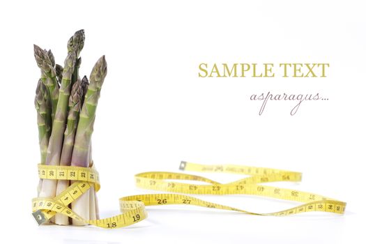 Raw asparagus and measuring type isolated on a white background